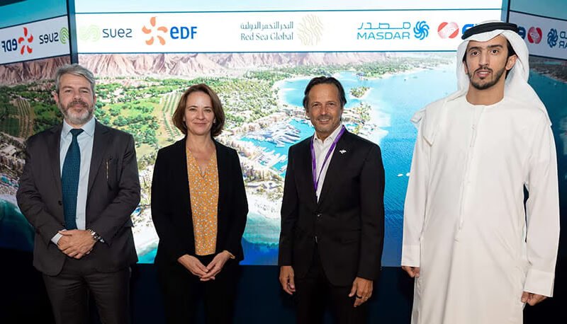 Representatives from EDF Group, Masdar, Korea East-West Power Co. (EWP), and SUEZ celebrate the $1.5 billion financial close for the AMAALA multi-utilities infrastructure project